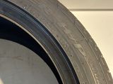 a tire on the side of a white truck