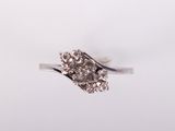 a close up of a diamond ring on a white background
