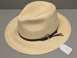 a white hat with a black band and a tag on it
