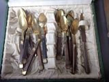 five spoons and two spoons in a box on a table