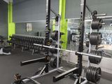 an image of a gym with a weight rack and weights