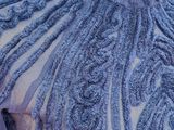 a close up of a blue dress with ruffles on it