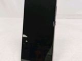 the back of a black cell phone sitting on top of a table