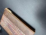 an image of a brown and red purse sitting on top of a table