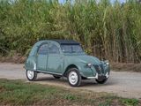 a green car that is parked on the side of the road