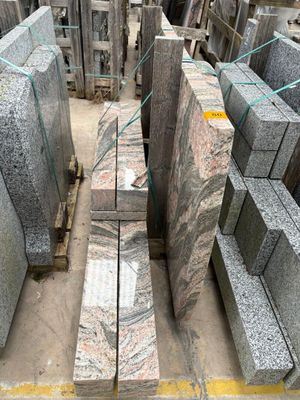a large pile of granite blocks sitting on a pallet