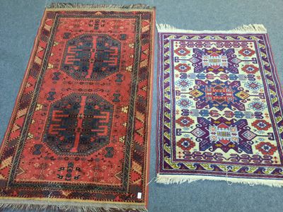 two oriental rugs on a carpet with a blue background