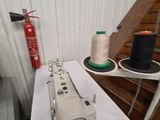 a sewing machine sitting on a table next to some spools of thread