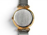 a watch that is sitting on a white surface