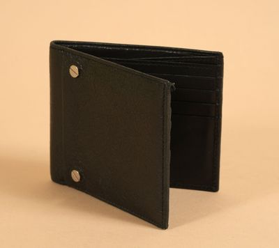 a black leather wallet with a metal button on the front