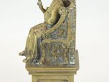 bronze statue of a woman sitting on a chair with a cup in her hand