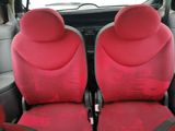 two red seats in the back of a car