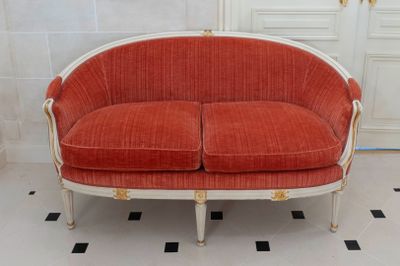 a red and white couch in a room with a black and white checkered floor