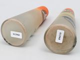 two vases with labels on them sitting on a table