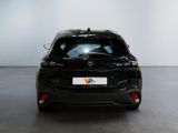 the back of a black car in a room with a white wall