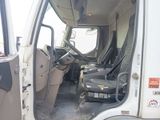 a white truck with the driver ' s seat in the back