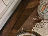 a plate and a vase sitting on a table