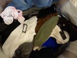 a pile of clothes that is sitting on a couch