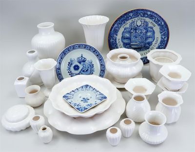 a lot of white and blue dishes and vases on the table