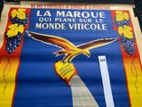 a large poster of a bird flying over a bunch of grapes