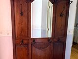a wooden cabinet with a mirror on top of it