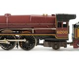 a toy train on a white surface with a white background
