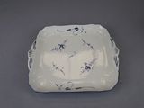 a white plate with blue flowers on it on a table