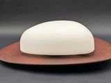 an image of a white soap dish on a wooden plate