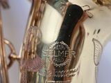 a silver and gold saxophone sitting on a table