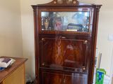 a wooden cabinet with a clock on top of it in a living room