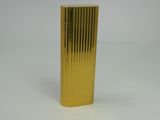 a gold lighter that is sitting on a white surface
