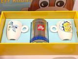 three coffee mugs in a yellow box on a table