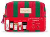 a red and green striped bag with three products in it