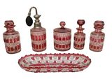 un ensemble de salle de bains en verre rouge comprenant un robinet, un distributeur de savon, un porte-savon et un distributeur de savon