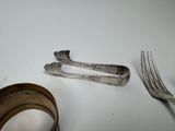 two forks and a knife on a table