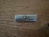 a small metal object on a wooden table