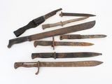 several different types of knives are displayed on a white surface