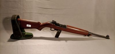 a rifle with a wooden barrel and a black stand on a white background