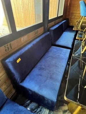 a blue couch and some chairs in a room