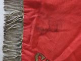 a close up of a red and gold flag with the letter s on it