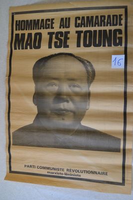 poster of mao tse young on the wall of a building