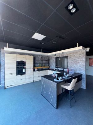 an image of a kitchen with a dining table and chairs