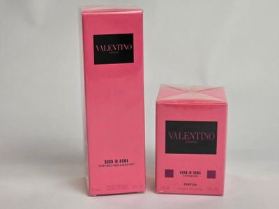 a close up of two boxes of perfume on a white surface