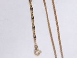 two gold chain necklaces on a white background