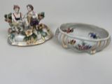 a small bowl and a small bowl with a figurine on it