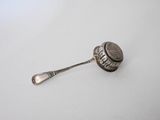 a spoon and a spoon rest on a white surface