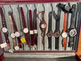 many different types of watches displayed in a display case