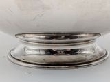 an image of a silver bowl sitting on top of a white table