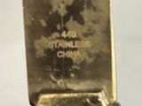 a close up of a metal object on a white surface