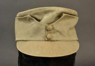 the hat is tan and has buttons on the front